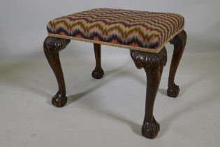 A Georgian style mahogany stool raised on carved cabriole legs with claw and ball feet, 57 x 46 x