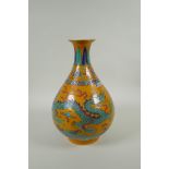 A Chinese yellow ground porcelain pear shaped vase with enamel decoration of a dragon and phoenix,