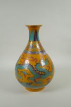 A Chinese yellow ground porcelain pear shaped vase with enamel decoration of a dragon and phoenix,