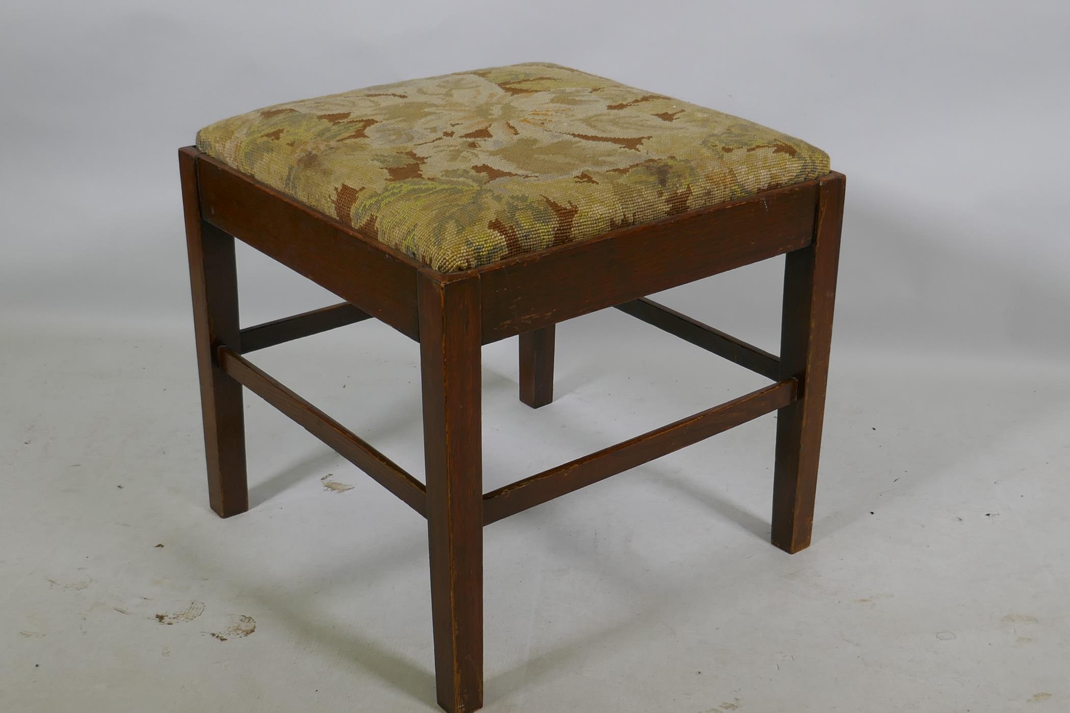 A C19th oak footstool with drop in tapestry seat, 45 x 45 x 45cm