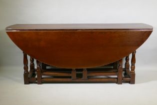 A large oak gateleg wake table, 200 x 152cm, 76cm high