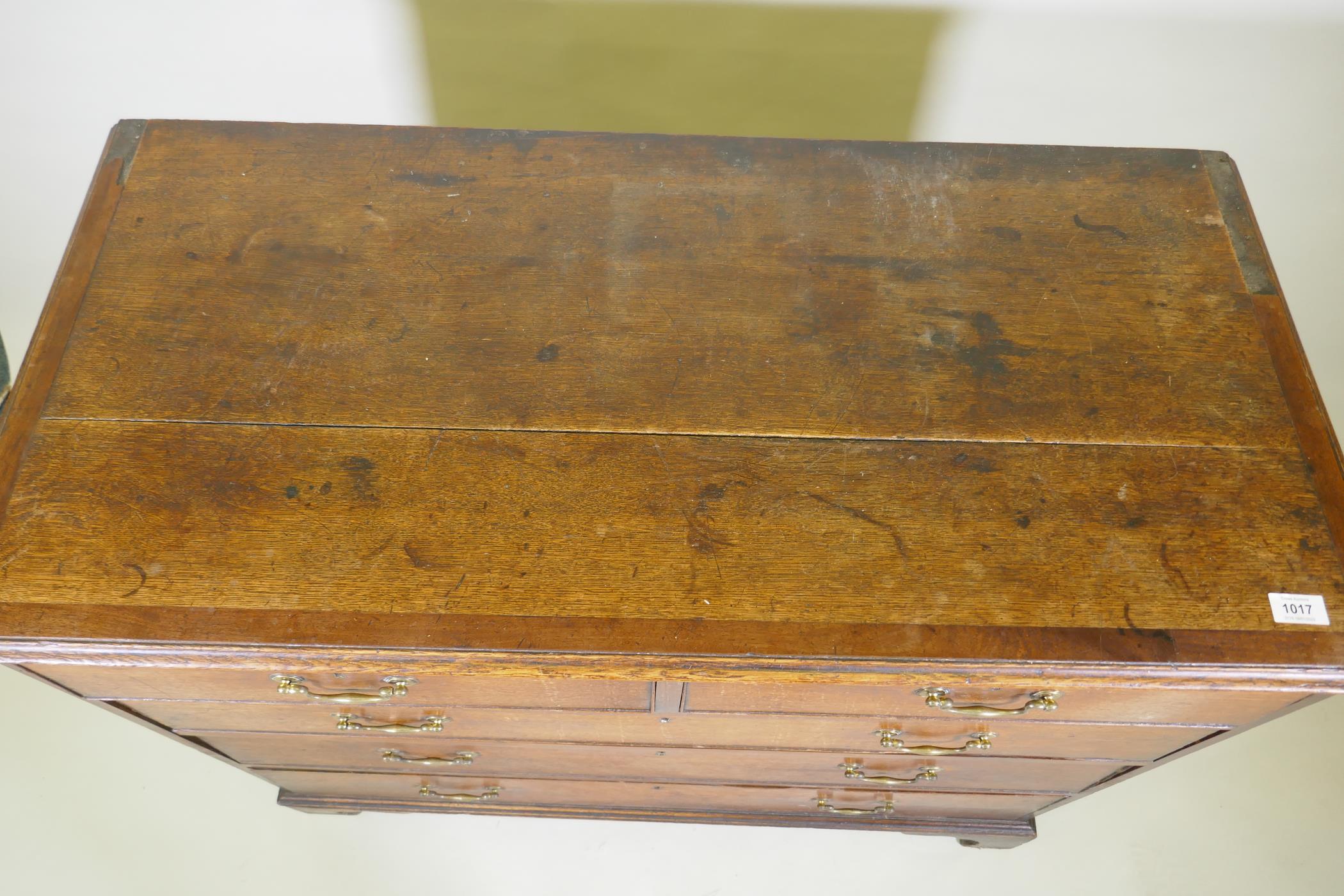 A Georgian oak chest of two over three drawers, mahogany banded top, cockbeaded drawers with - Image 4 of 7