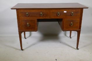 A Victorian mahogany kneehole desk with satinwood banding inlay and brass handles, four drawers