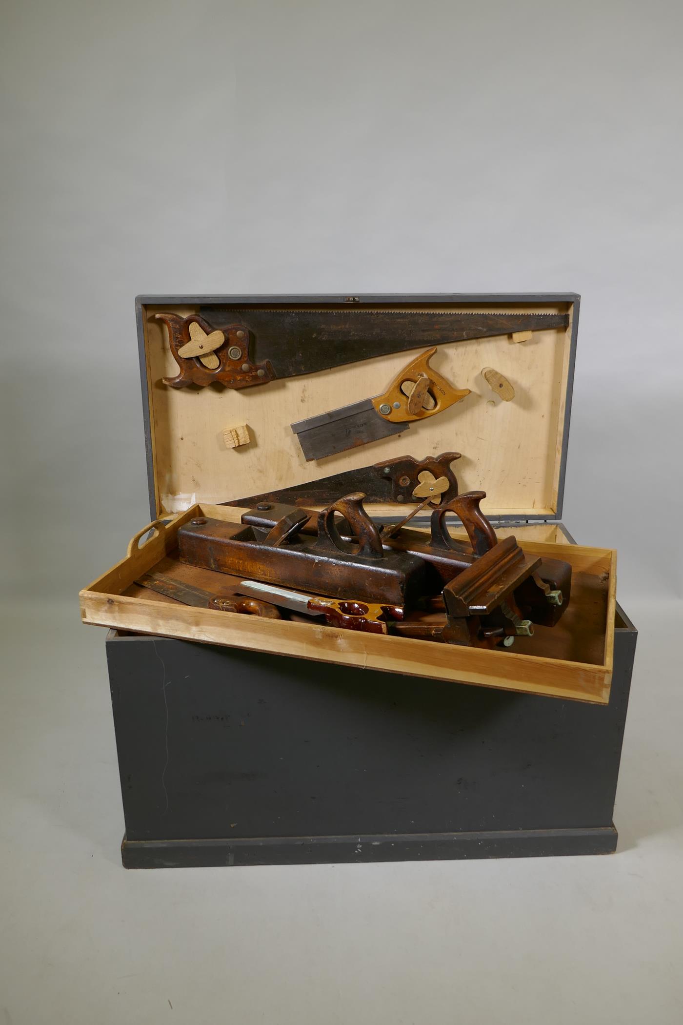 A vintage painted tool chest containing a collection of carpenter's tools, 78 x 43cm, 47cm high