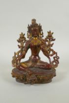 A Tibetan bronze figure of white tara with gilt and copper patina, 20cm high