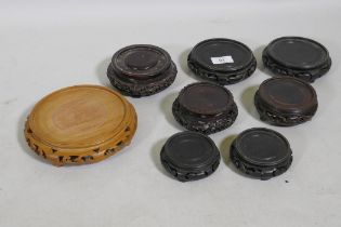 A collection of Chinese hardwood vase stands including a pair, 10cm diameter rebate, and another