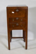 A Georgian mahogany gentleman's washstand, the fold out top with fitted interior and turned wood