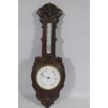 A late C19th/early C20th carved oak wall barometer, the dial inscribed Maple & Co, London, 90cm high