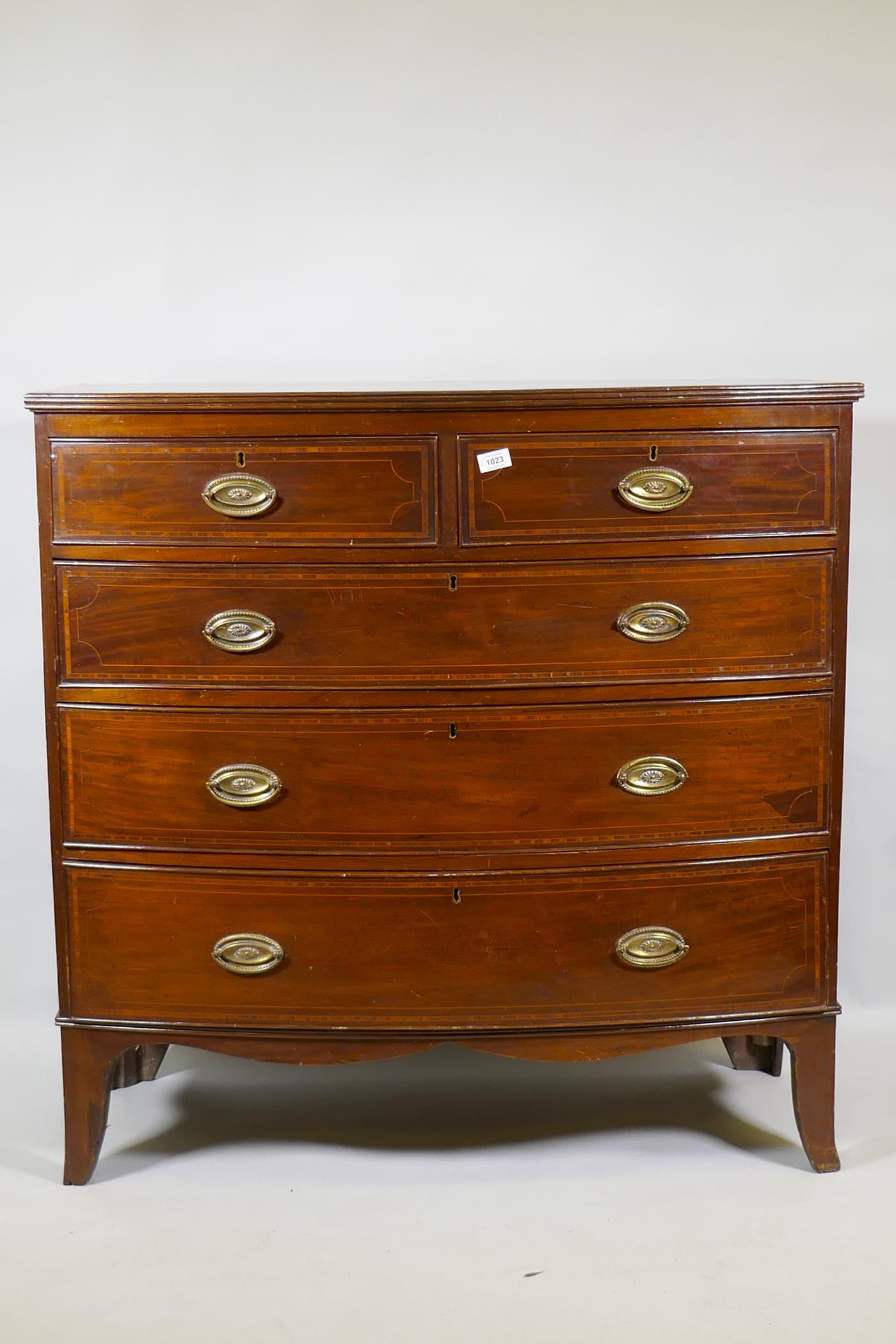 A George III inlaid mahogany bowfront chest of two plus three drawers, with brass plate handles,