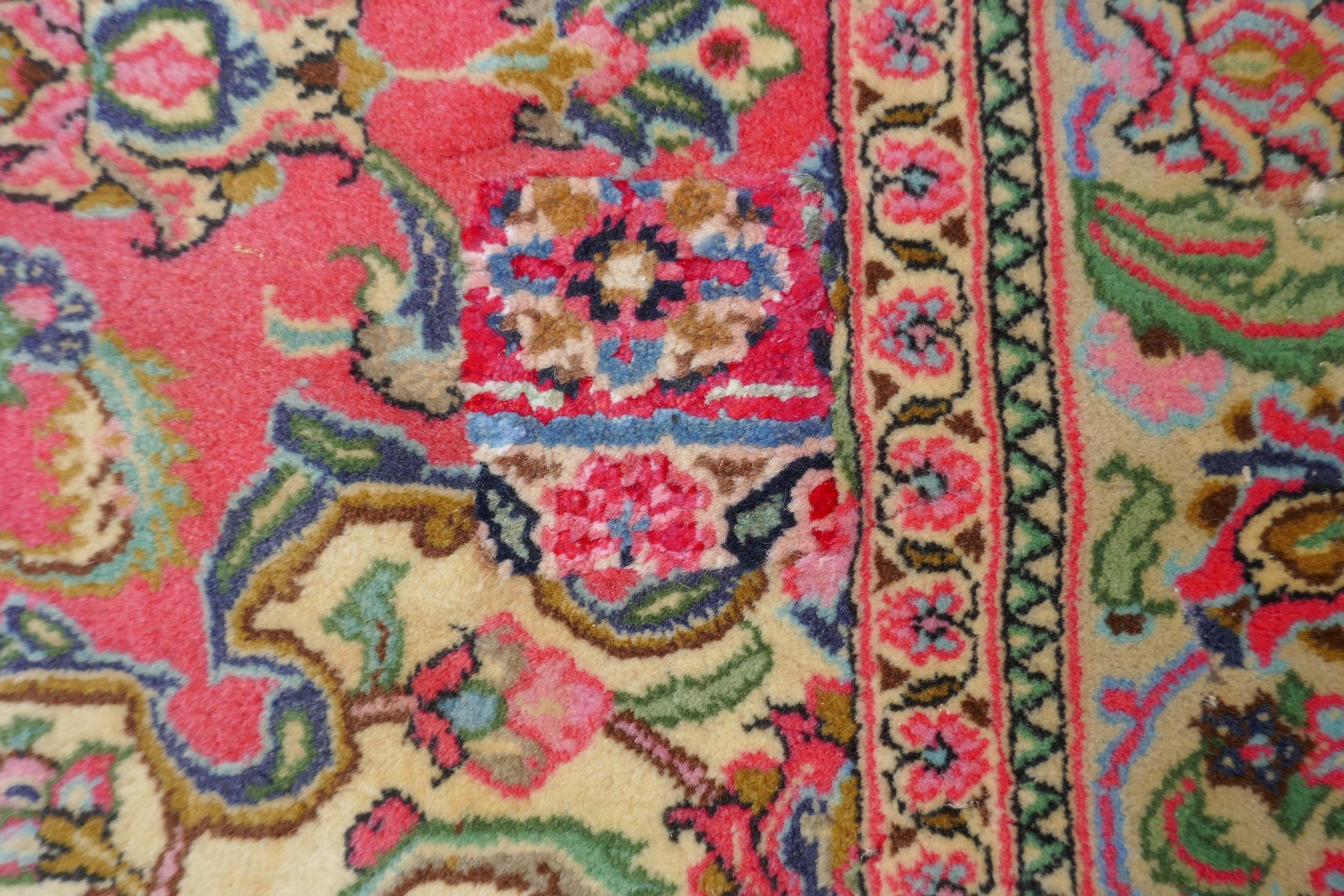 A very fine hand woven Persian Kashan rug with floral medallion design on a pink field, patched, 172 - Image 4 of 9