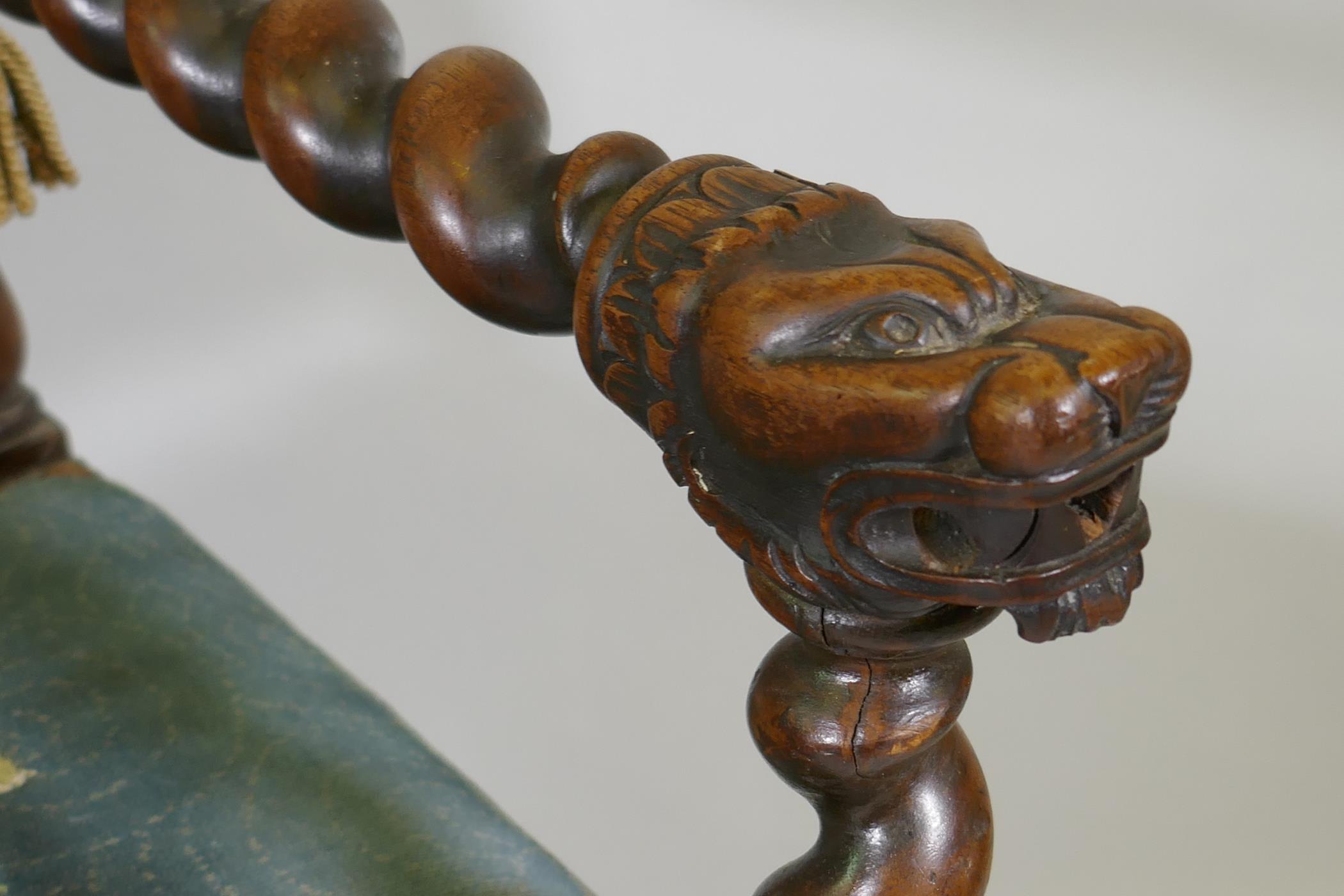 A Jacobean style walnut open armchair with barley twist and carved lion decoration, studded tapestry - Image 2 of 3