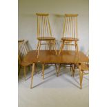 An Ercol Grand Windsor blond elm and beech extending dining table Model 444, and six matching Ercol