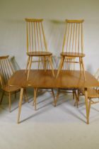 An Ercol Grand Windsor blond elm and beech extending dining table Model 444, and six matching Ercol