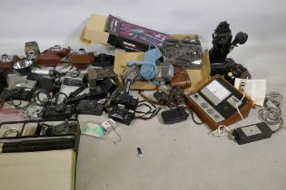 A collection of vintage 35mm cameras, Pentax, Kodak Pony 135, Olympus Pen, flashlights, video