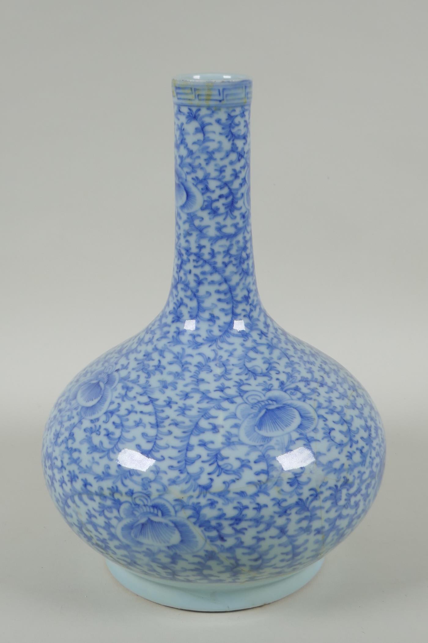 A C19th Chinese blue and white porcelain bottle vase with scrolling floral decoration, AF repair,