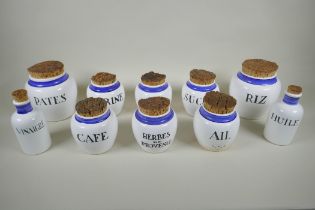 Ten French ceramic blue and white storage pots and bottles with cork lids, largest 17cm  high