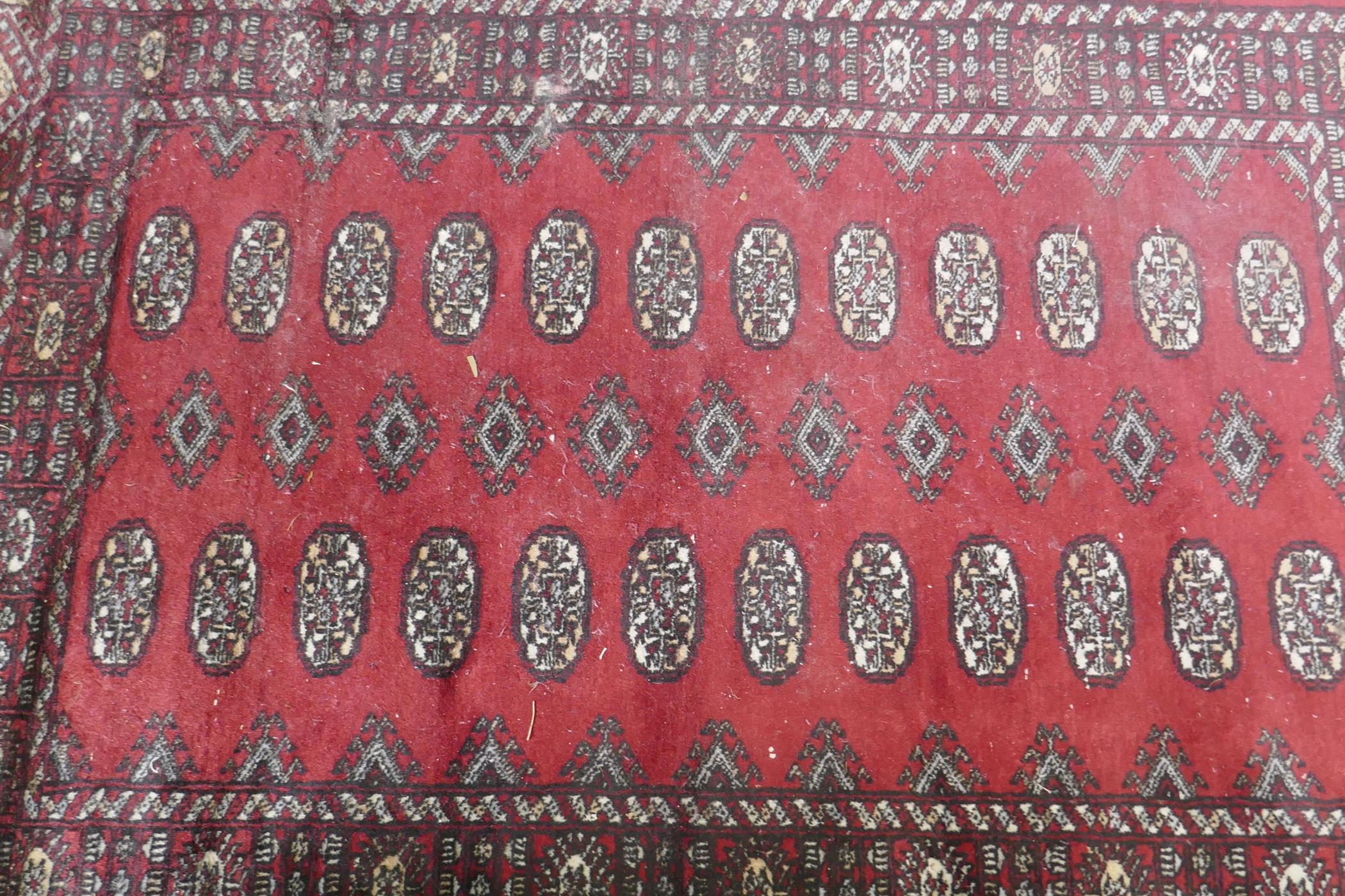 A Bokhara hand woven wool rug, red ground with traditional pattern, 7 x 157cm - Image 2 of 3