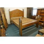 An oversize pine bed, the head boards capped with metal mounts, by repute formerly the property of