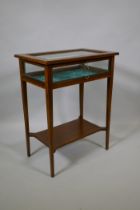 An antique inlaid mahogany vitrine on square tapering supports united by an under tier, 56 x 36cm,