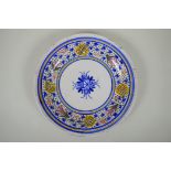 An antique Delft plate decorated with a floral design, 32cm diameter