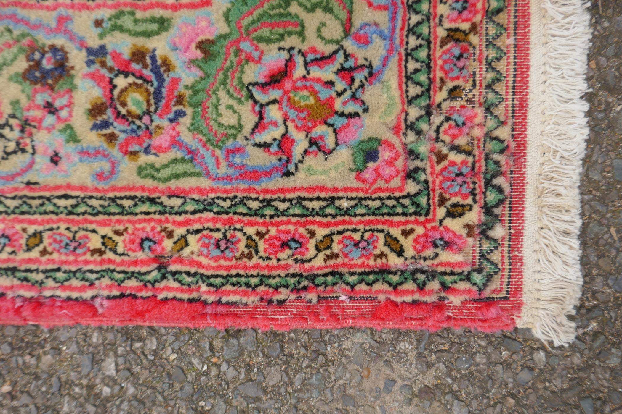 A very fine hand woven Persian Kashan rug with floral medallion design on a pink field, patched, 172 - Image 5 of 9