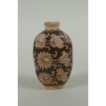 A Chinese Cizhou kiln snuff bottle with lotus flower decoration, 7cm high
