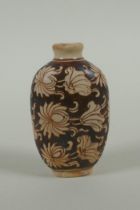 A Chinese Cizhou kiln snuff bottle with lotus flower decoration, 7cm high