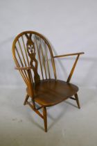 A vintage Ercol elm Fleur de Lys armchair