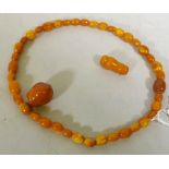 A vintage amber bead necklace and two loose beads, 24g, 36cm long