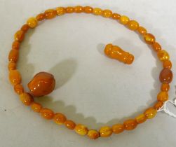 A vintage amber bead necklace and two loose beads, 24g, 36cm long