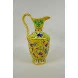 A Chinese yellow ground porcelain fahua ewer decorated with prunus blossom and cypress trees, 32cm