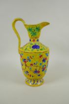 A Chinese yellow ground porcelain fahua ewer decorated with prunus blossom and cypress trees, 32cm