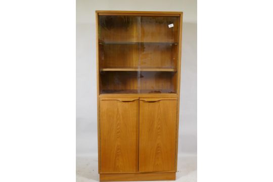 A mid century teak cabinet, with sliding glass doors over two cupboards, 69 x 36 x 144cm - Image 1 of 2