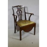 A Georgian mahogany Chippendale style elbow chair with pierced splat back, scroll arms and drop in