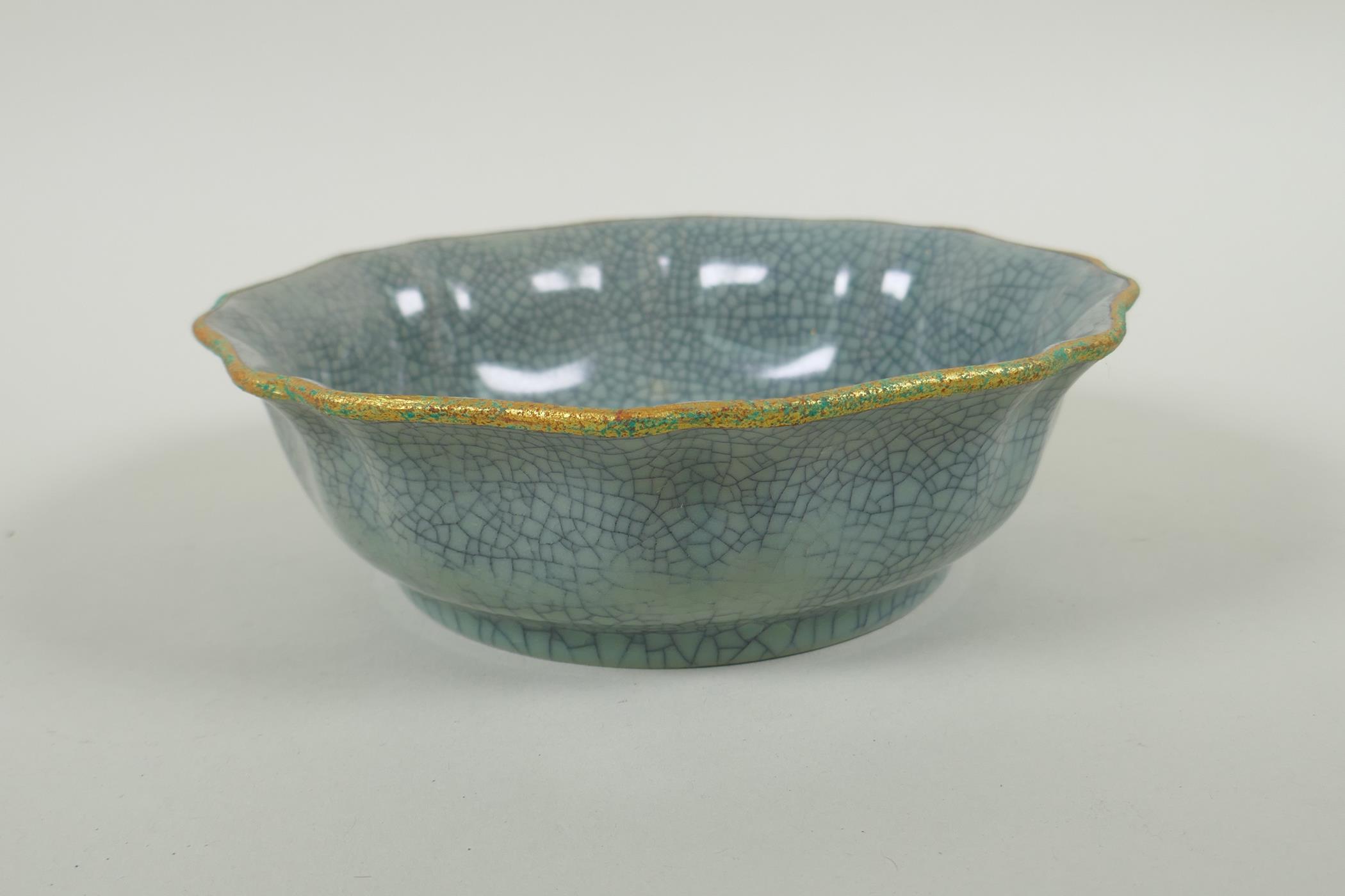A Chinese celadon crackleware bowl of lobed form, with a gilt metal rim and chased character - Image 2 of 4