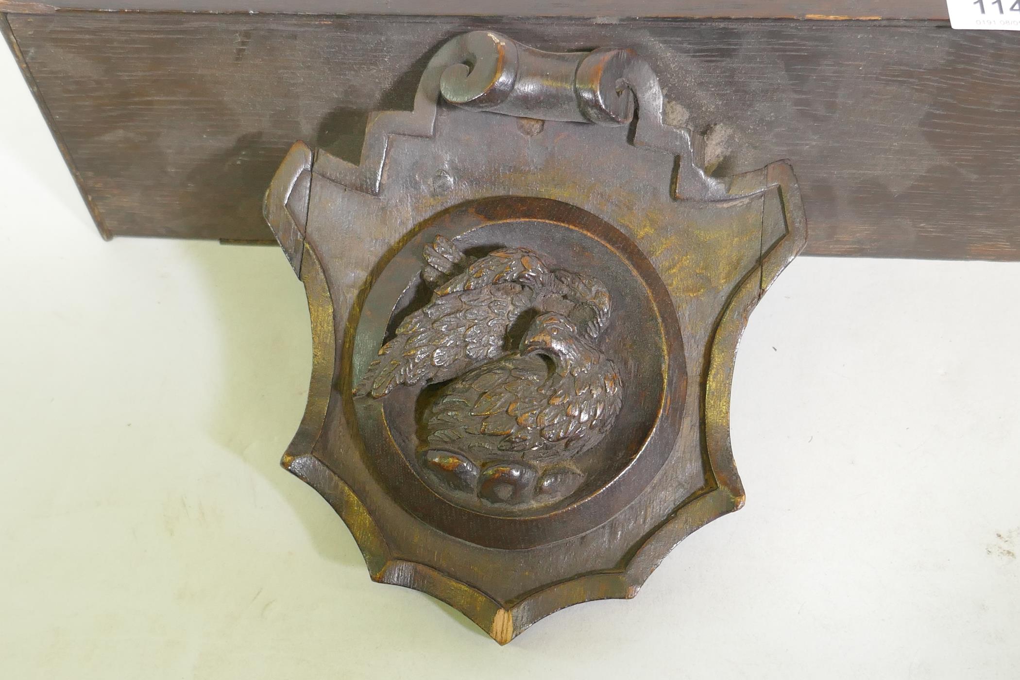 An C18th/C19th French oak shelf with carved brackets decorated with a bird and an angel, 72 x 13 x - Image 3 of 4