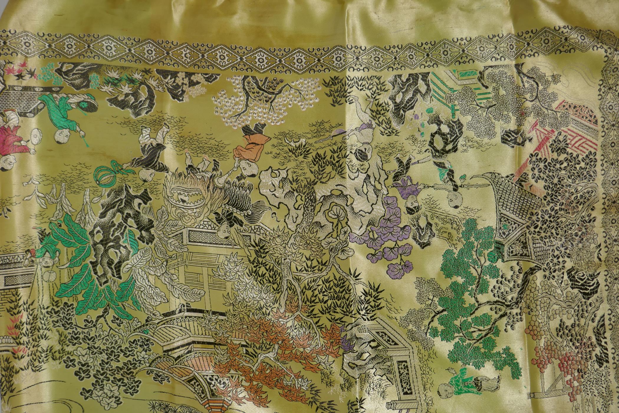 A Chinese machine embroidered gold ground silk throw decorated with boys playing in a garden, - Image 2 of 5
