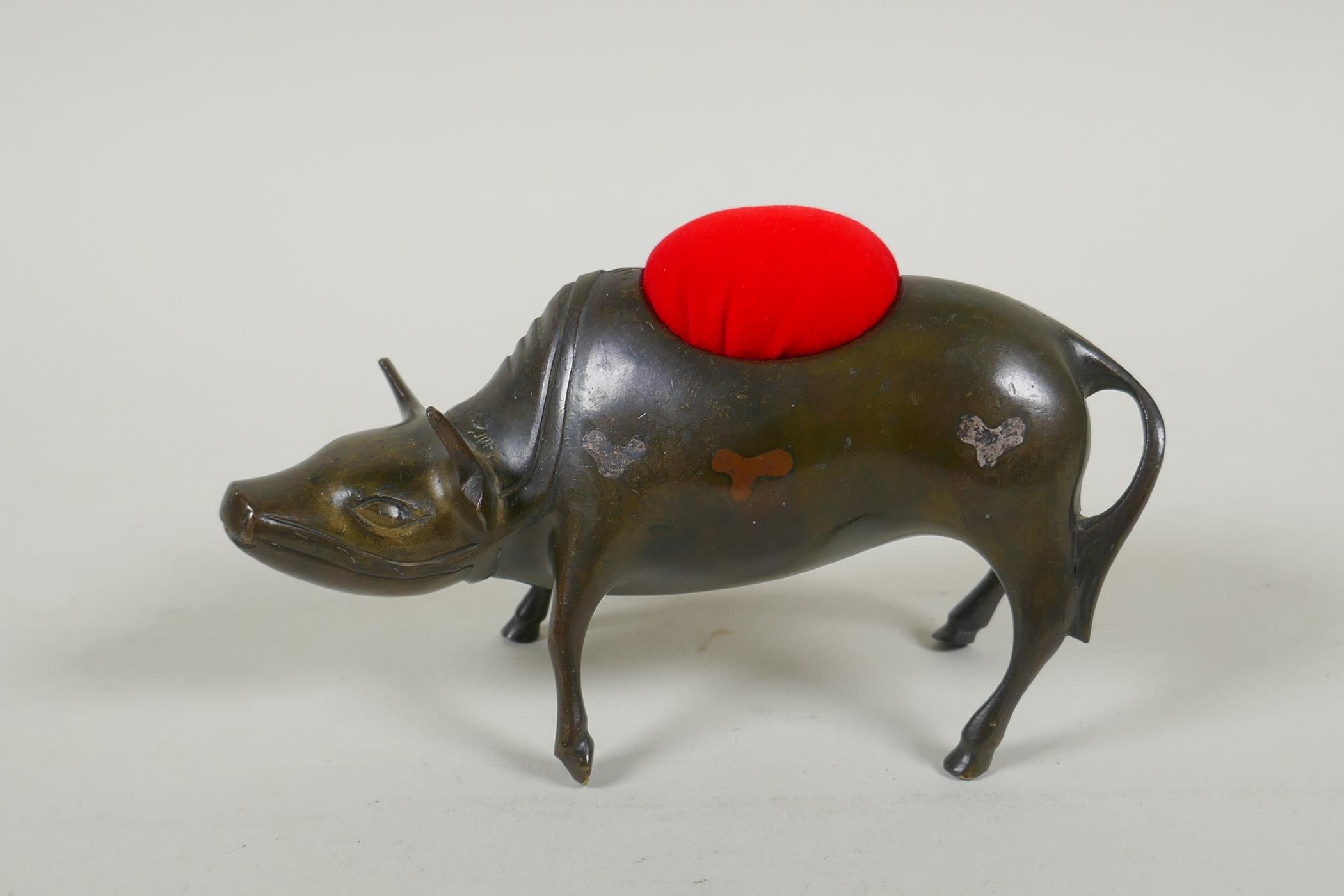 A Japanese Mokume-gane metalware pin cushion in the form of a buffalo, with inlaid decoration,