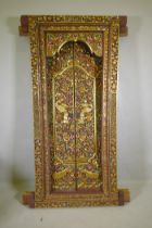 Architectural Salvage, an Oriental carved, painted and parcel gilt set of doors and frame, with