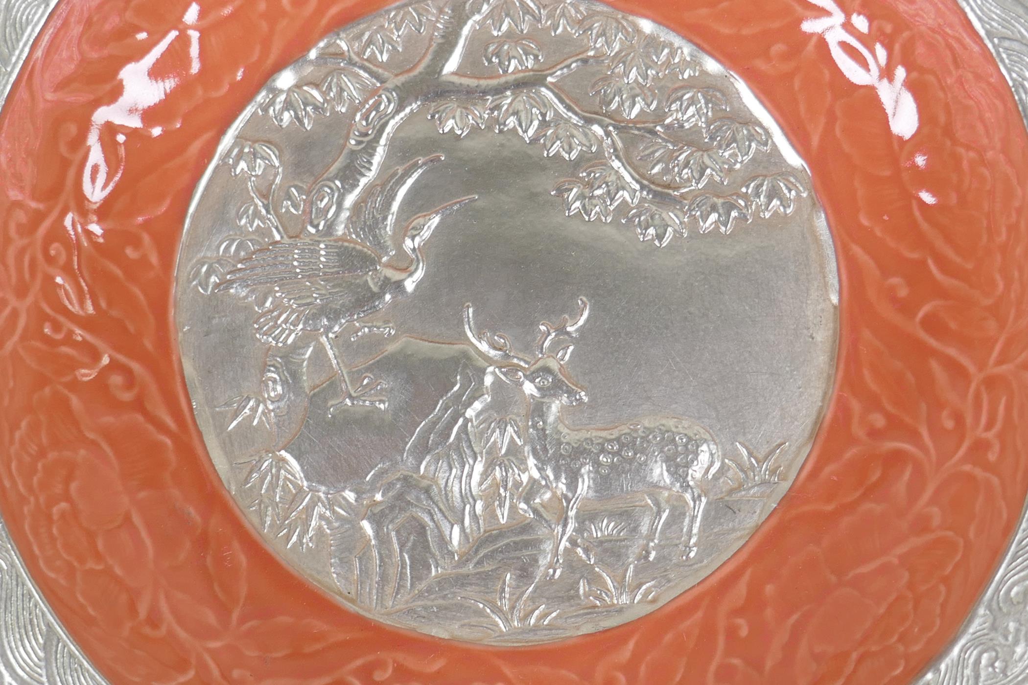 A Chinese salmon pink and silver glazed porcelain dish with lobed rim, with raised deer and crane - Image 2 of 5