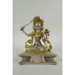 A Tibetan white metal figure of green tara, double vajra mark to base, 21cm high