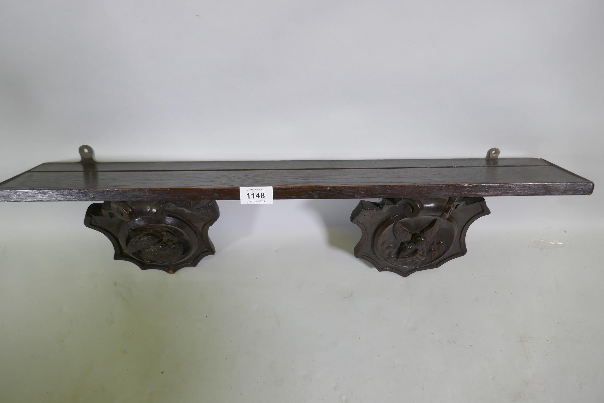 An C18th/C19th French oak shelf with carved brackets decorated with a bird and an angel, 72 x 13 x - Image 4 of 4
