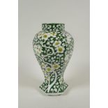 An antique Chinese green ground porcelain baluster vase of hexagonal form, with allover prunus