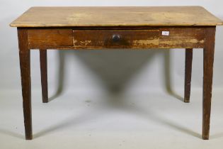 An early C19th pine scullery table with single drawer and scrubbed top, raised on tapering supports,