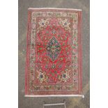 A very fine hand woven Persian Kashan rug with floral medallion design on a pink field, patched, 172