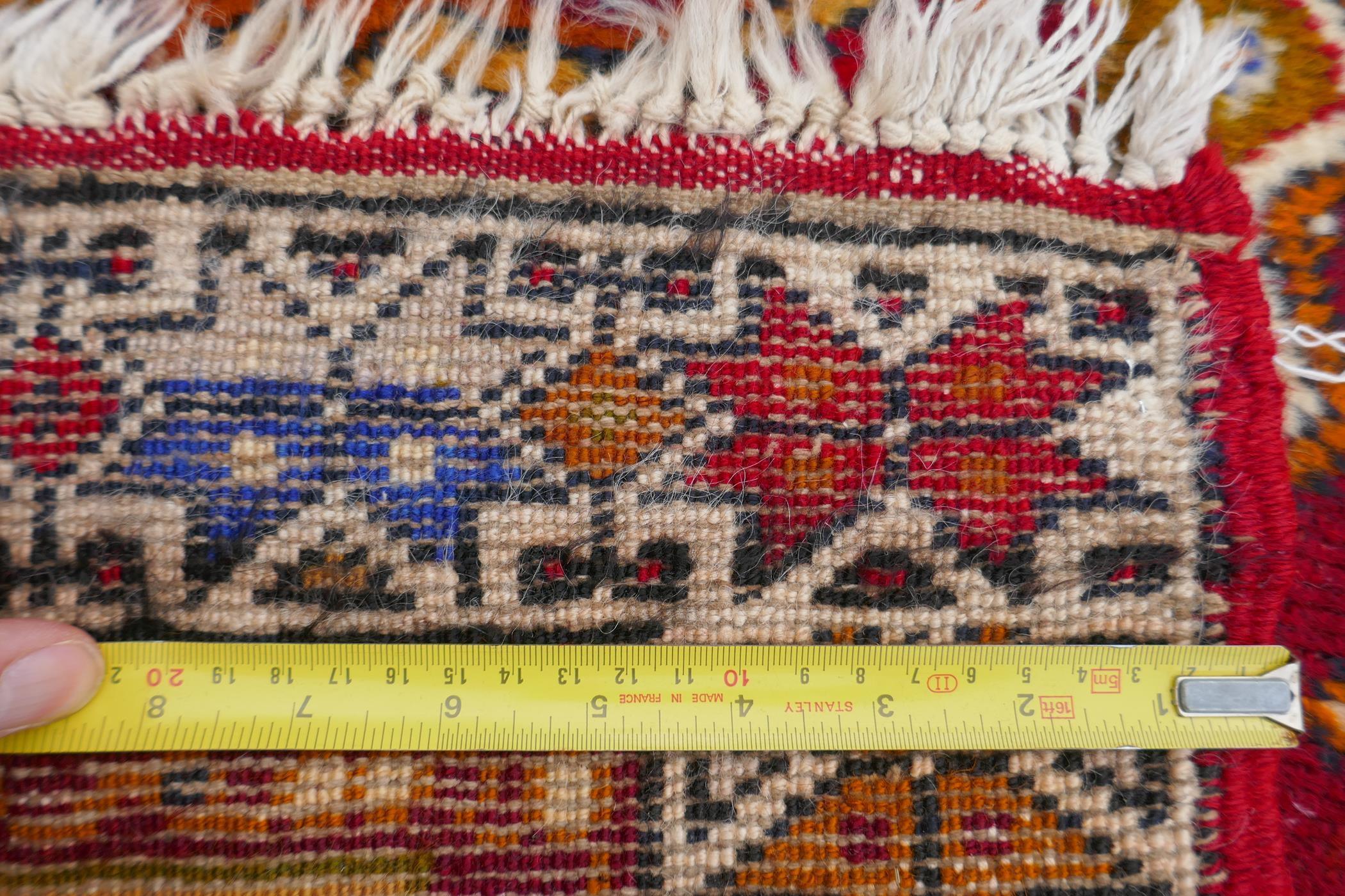 A rich red ground Caucasian rug with prayer mat design and multi-colour borders, 112 x 186cm - Image 3 of 3