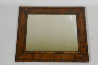 A William and Mary well figured walnut veneered cushion mirror with antique glass, 59 x 50cm