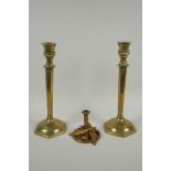 A studio art coper and brass hand assembled candle stick, decorated with feathers, signed to the