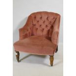 A Victorian button back nursing chair, raised on turned supports