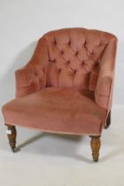 A Victorian button back nursing chair, raised on turned supports